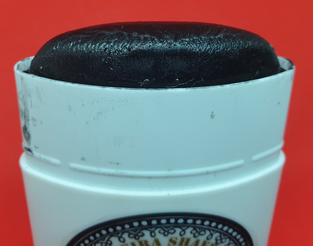 An uncapped shaving stick with Pereira charcoal soap